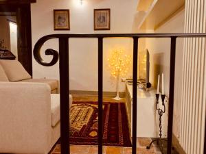 a view of a living room with a couch and a table at Casa il Cassero in Castiglion Fiorentino