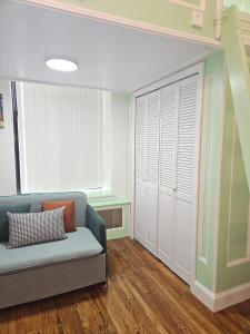 a living room with a couch and a window at The Harlem Getaway in New York