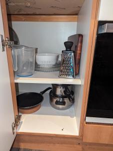 a cabinet filled with dishes and other kitchen items at The Pinnacle 4/5 in Glasgow