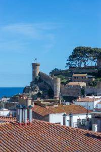 a view of a town with a castle on a hill at Hostal Boutique Sa Nansa in Tossa de Mar