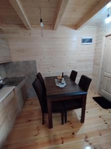 a dining room with a wooden table and chairs at Brvnara Katun in Žabljak