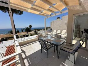 a patio with a table and chairs on a balcony at Serenity Corner in Paphos