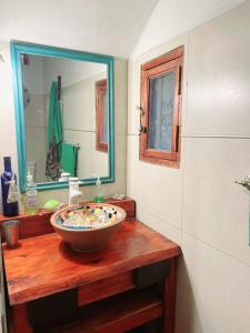 a bathroom with a bowl sink and a mirror at Lunas de Spilimbergo in Córdoba