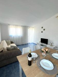 a living room with a table and a couch at Apartments Ema in Sali