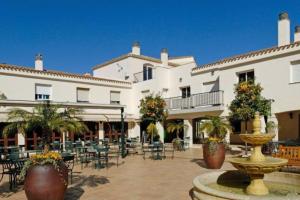 a courtyard with a fountain in front of a building at La Manga Club Resort - 3 bedroom Duplex - La Colina in Atamaría