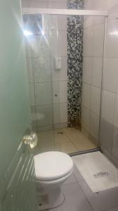 a bathroom with a toilet and a shower at Pousada ACRÓPOLE in Belém