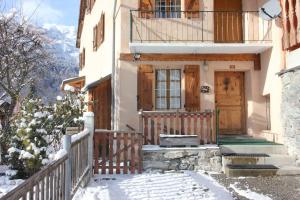 a house with a wooden door in the snow at Atmospheric, original stone chalet in Meribel in Les Allues