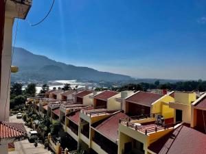 an aerial view of a city with buildings and a mountain at Luxe Ganga view Villa with Terrace Seating (Vacaow) in Rishīkesh