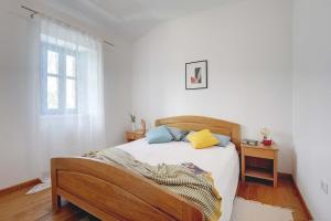 Schlafzimmer mit einem Bett mit weißer Bettwäsche und einem Fenster in der Unterkunft Villa Nina in Vodnjan