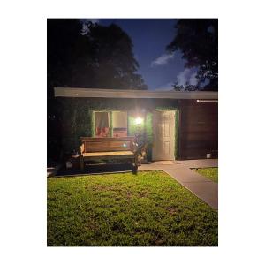 a house with a bench in the yard at night at Little Cottage in Miami