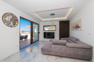 a living room with a couch and a television at Villa Hillson in Makarska