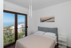 a bedroom with a bed and a large window at Villa Hillson in Makarska +36 photos
