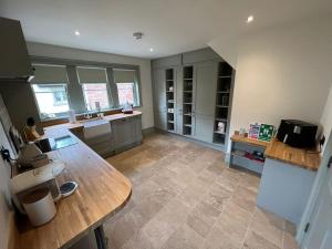 a large kitchen with a wooden table in a room at Cosy hideaway in leafy Lytham in Lytham St Annes