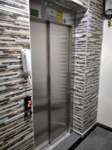 an elevator in a bathroom with a stone wall at Moataz in Madinaty