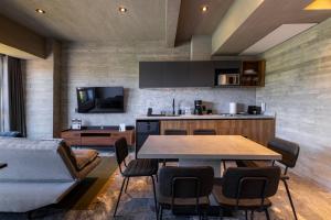 a kitchen and living room with a table and a couch at Park Condesa by Capitalia in Mexico City