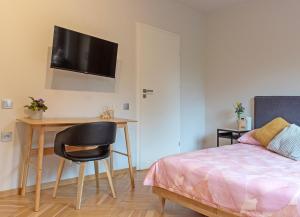 1 dormitorio con escritorio, 1 cama y 1 mesa en Aparthotel STUDIO, en Cracovia