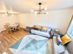 a living room with a couch and a table at LUXstay 2BR Earls Court Apartment Sleeps up to 10 in London