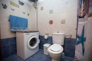 a bathroom with a toilet and a washing machine at Natural Quiet Accommodation in Kallithea Rhodes +23 photos