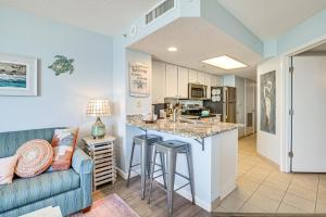 a living room with a couch and a kitchen at Steps to Boardwalk Condo with Pool in Myrtle Beach in Myrtle Beach