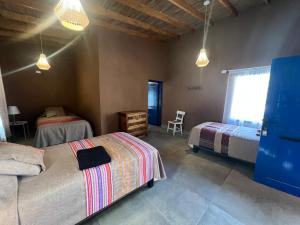 Ліжко або ліжка в номері Ckoi Atacama Lodge