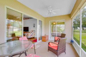 a dining room with a glass table and chairs at Ocala Home with Screened-In Porch and Community Perks! in Marion Oaks
