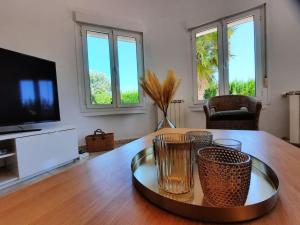a living room with a table and a tv at Casa Angela, Gata de Gorgos with heated pool in Gata de Gorgos