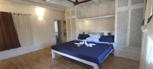 ワタムにあるOcean zuri villaのベッドルーム1室(青いシーツと青いベッドサイドシックス付)