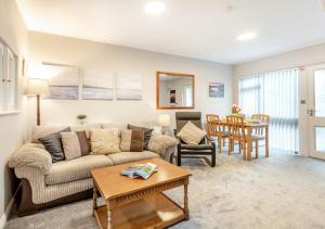 a living room with a couch and a table at Mews Cottage in Grasmere