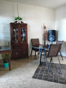 a dining room with a table and chairs and a cabinet at Casa acogedora in Calderas