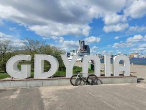 a bike parked in front of a large sign at Apartament 2-pokojowy Gdynia - Trójmiasto in Gdynia