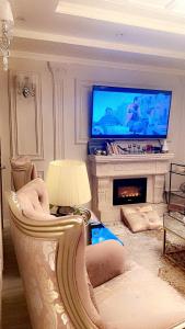 Haiat Villa في الرياض: غرفة معيشة بها أريكة وتلفزيون
