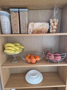 a shelf with two bowls of fruit and other food at House of Peace in Oxford