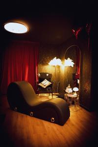 a dark room with a chair and a mirror at Love room Casa Amore sauna balnéo 66 Occitanie in Prades