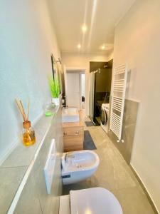 a bathroom with a white toilet and a sink at Comoluxhouse- Intero appartamento in Como