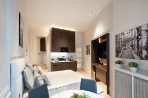 a living room with a bed and a kitchen at SAINT- PAUL - LUXURY APARTMENT IN HOTEL DE VILLE in Paris