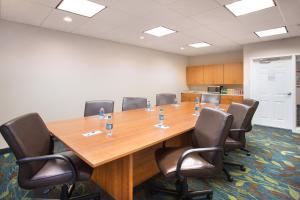 a conference room with a large wooden table and chairs at Candlewood Suites Yuma, an IHG Hotel in Yuma
