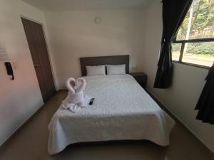a stuffed bunny sitting on top of a bed at HOSPEDAJE SiLOM in Bogotá
