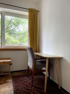 a room with a table and a chair and a window at Pod Modrzewiem in Sokołowsko