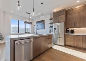 a kitchen with wooden cabinets and stainless steel appliances at Mountain House PC in Keetley
