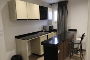 a kitchen with a counter top and a microwave at لوكاندة الحصري أكتوبر motel elhosary in 6th Of October