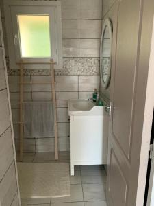 a small bathroom with a sink and a mirror at la maison bel air in Limoux +3 photos