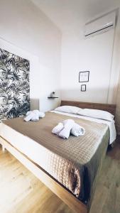 a bedroom with a bed with two towels on it at Monteleone rooms in Palermo