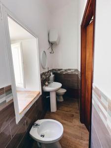 a bathroom with a sink and a toilet and a mirror at Monteleone rooms in Palermo +15 photos