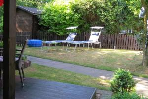 two chairs and a table in a yard at Sehr schönes Ferienhaus auf eingezäunten Grundstück mit Kamin und einer Sauna in Extertal +10 photos