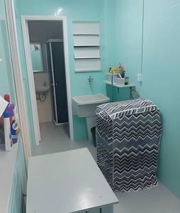 a blue bathroom with a sink and a toilet at Casa Azul in Rio das Ostras +10 photos