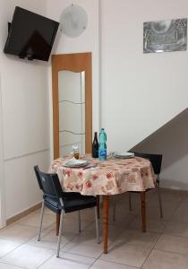 a table with a table cloth on it with two chairs at Casa Bianca in Marina di Massa