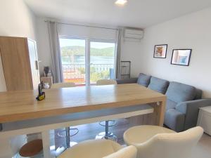 a living room with a table and a couch at nautic world studio in Tisno