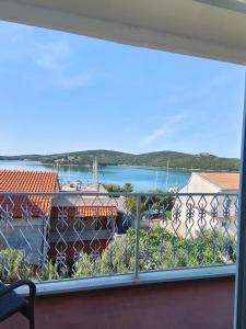 a balcony with a view of a river and a boat at nautic world studio in Tisno +17 photos