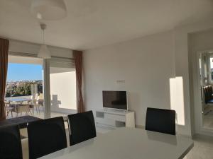a living room with a table and a television at Villa Sunny Day Sendi Deluxe - Novalja in Novalja