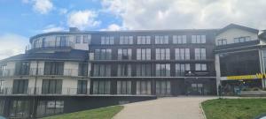 a large building with a lot of windows at Czarna Perła Apartamenty Czarna Góra 402 in Sienna